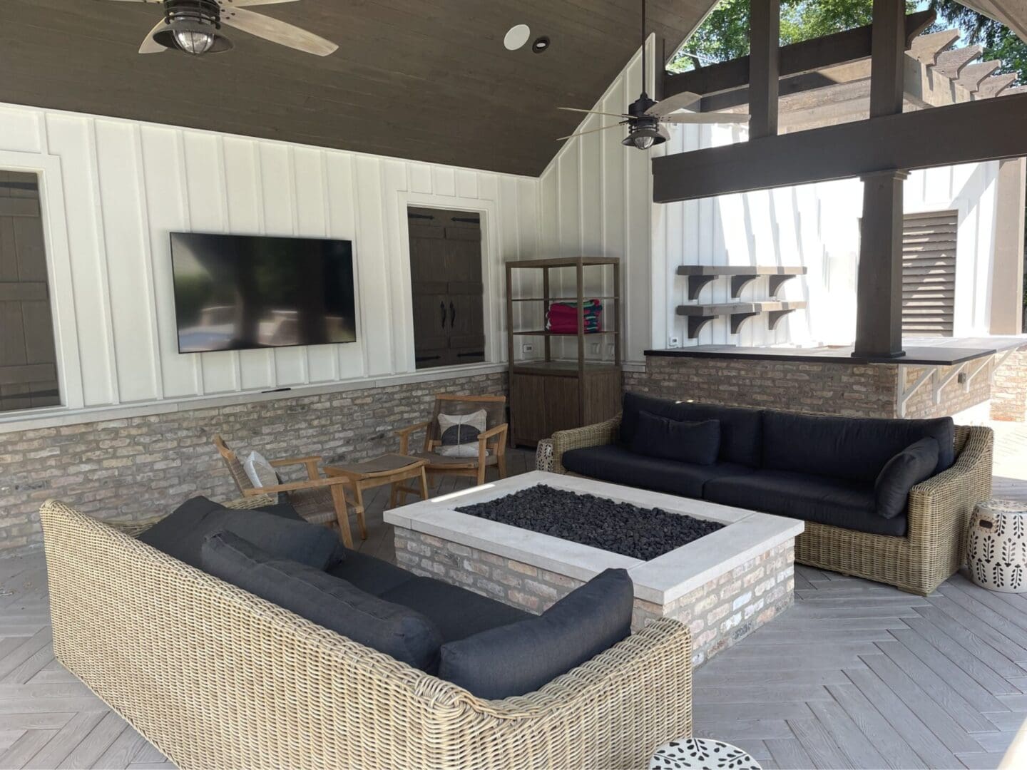 Custom fire pit under luxury style pergola style patio installation in Hinsdale, IL