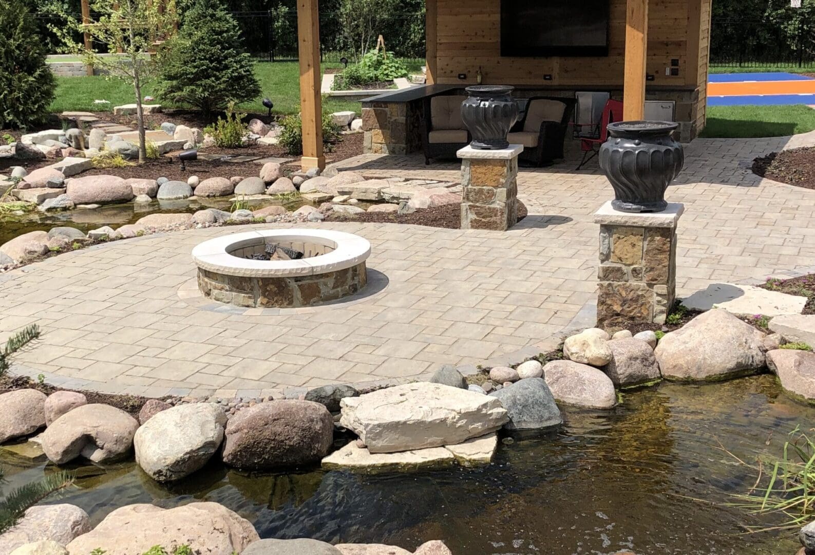 Natural stone patio with custom fire pit and pavilion in Burr Ridge IL