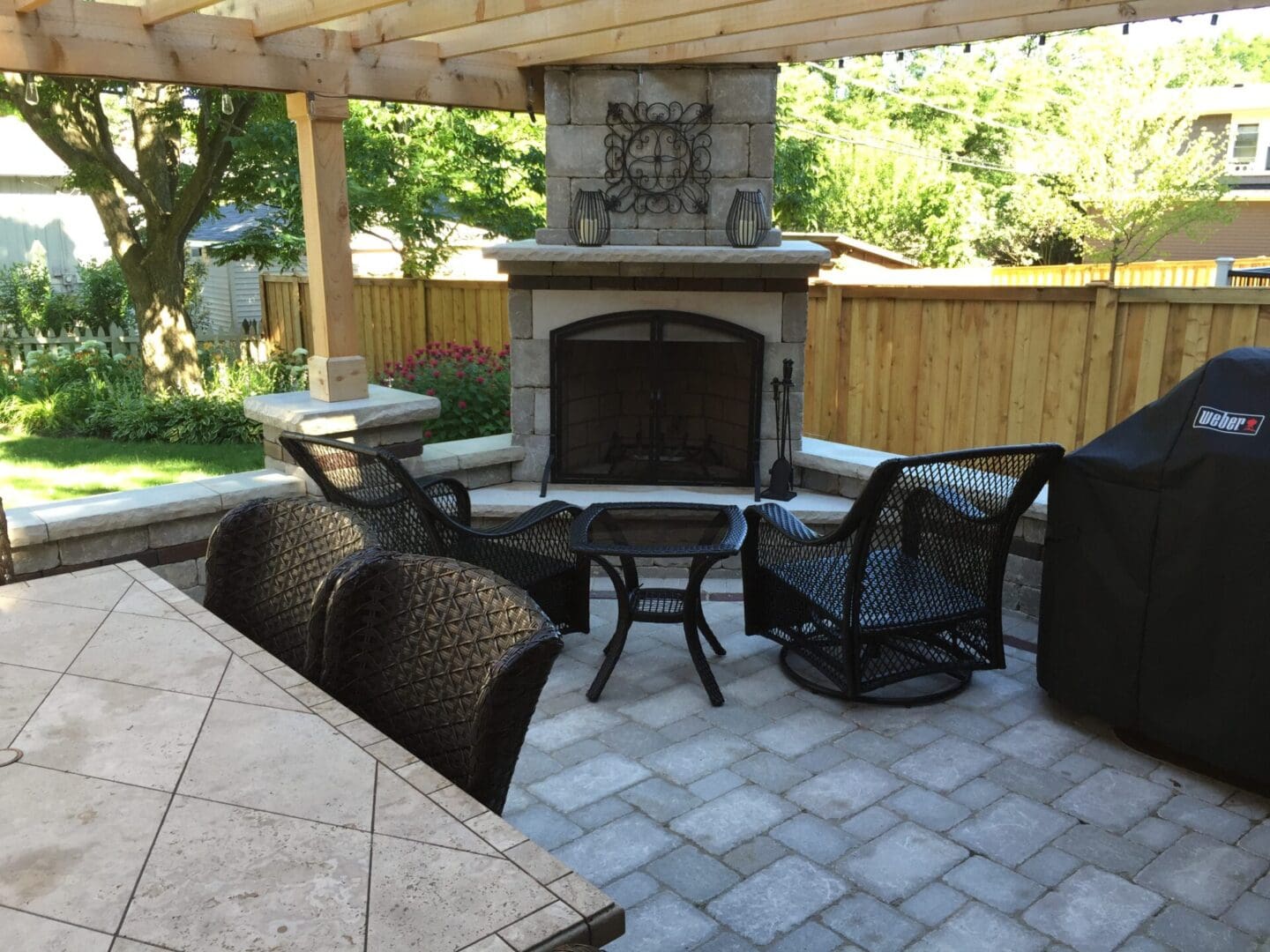 Custom outdoor fireplace with pergola installation in Western Springs, IL